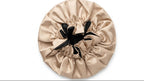Beige satin hair cap with black interior on a white background