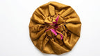 Gold Satin Hair Bonnet with pink interior on a white background