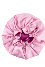 Pink satin hair bonnet on a white background