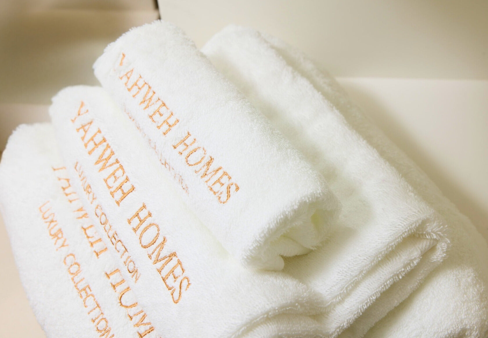 White towels with 'Yahweh Homes' branding 