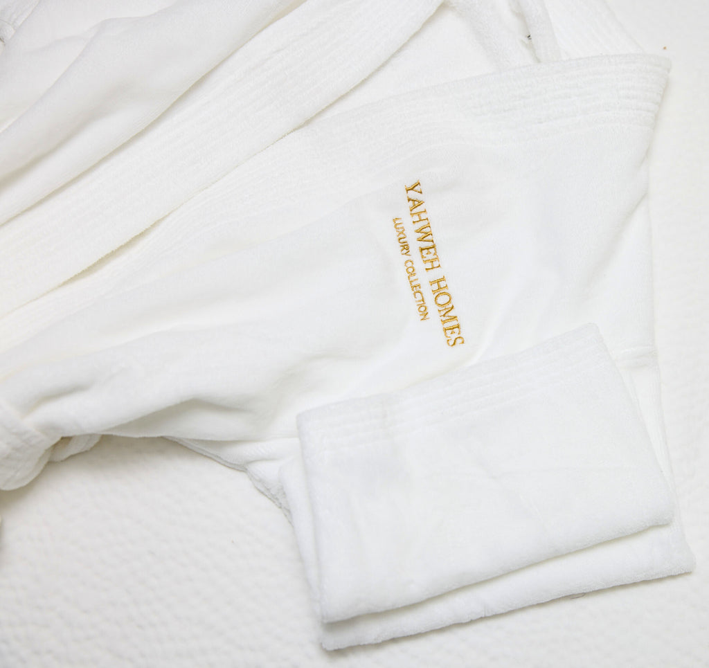 White robe with 'Yahweh Homes' embroidery on a white background