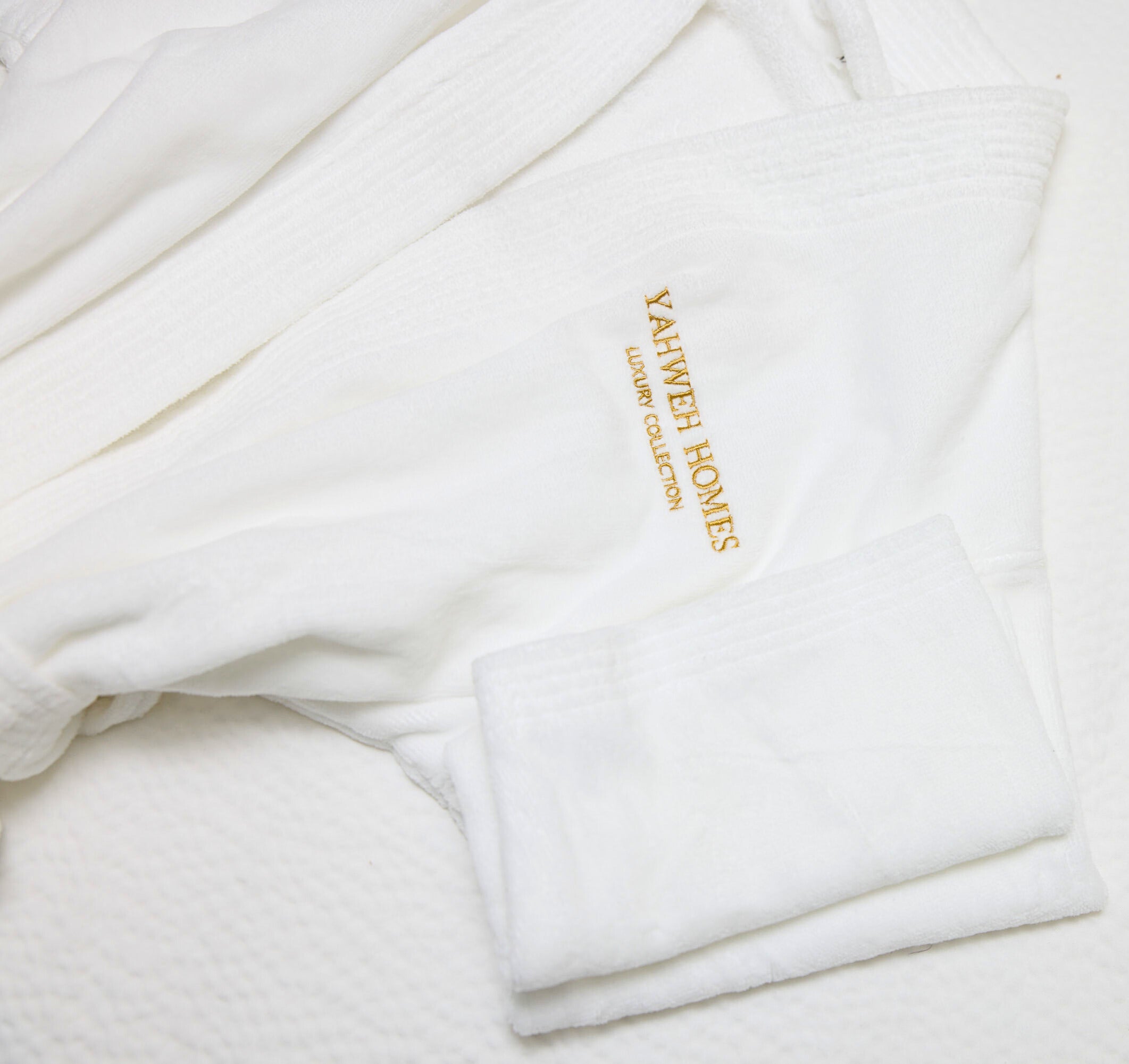White robe with 'Yahweh Homes' embroidery on a white background