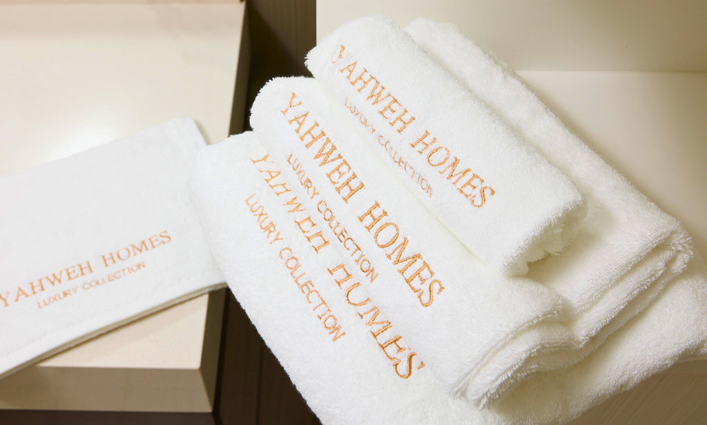 White towels with 'Yahweh Homes' branding.