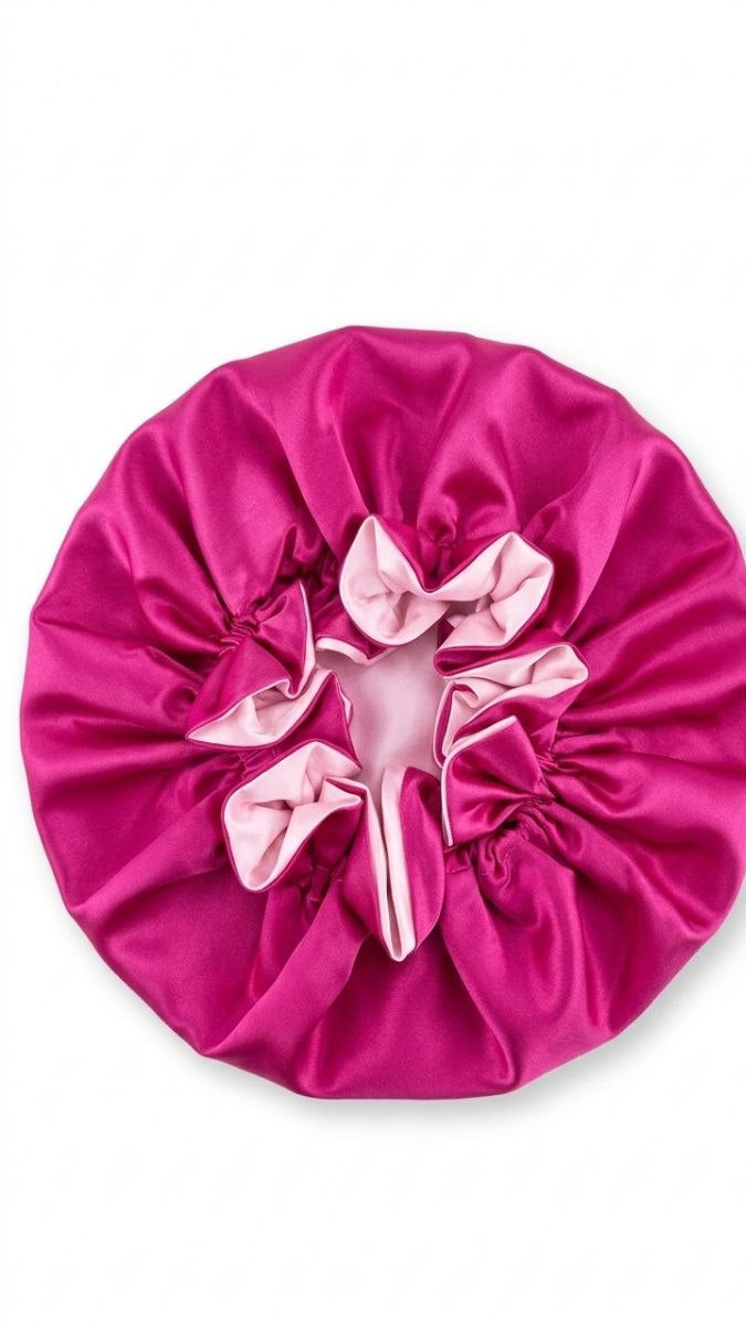 Pink satin bonnet on a white background